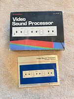 Box and owner's manual displayed on carpet