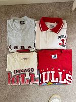 Four shirts laid flat showing fronts and colours