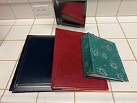 Top view of four photo albums showing covers and sizes