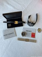 Lot overview showing all watches, Seiko box and manuals