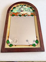 Full view of arched mirror showing unicorn glass panel and frame condition