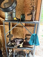 Shelving with clear tote containing assorted galvanized rodent traps and bait boxes