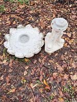 Top view of scalloped bowl beside pedestal on ground