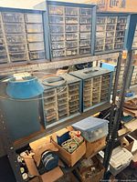 Front view of rack showing drawer cabinets, lamp shade, boxes of supplies