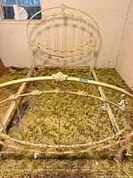 Full view of assembled cream metal bed frame showing headboard, footboard and rails