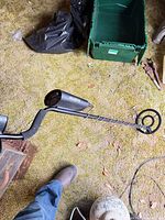 Full view of metal detector showing shaft, control box, armrest, and search coil