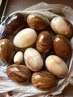 Group of 11 polished stone eggs in plastic bag