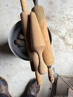 Top view of wooden utensils resting on grey bucket