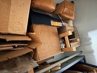 Cardboard boxes, small studded leather pouch, assorted storage visible