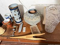 Overview of pottery, crystal vase, tools on tabletop