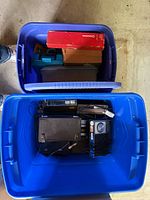 Two stacked blue totes with contents visible