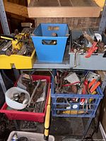Overview of shelf with four bins containing assorted tools