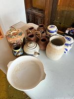 Overview of mixed pottery and kitchen ceramics on table