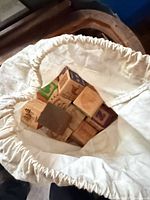 Alphabet blocks inside cloth bag