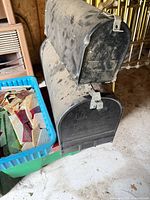 Two stacked mailboxes, plastic tote with stained glass visible