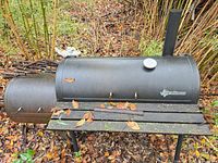 Full view of smoker with side firebox, wooden shelf, thermometer
