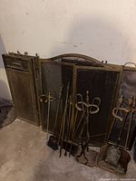 Overall lot showing screen, tools, andirons, ash pan