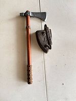 Flat iron and axe full view on table