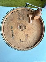 Top view of lid showing stamped "SPRING '64" and wooden spigot valve