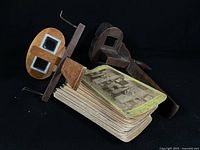 Two stereoscope viewers and stack of cards