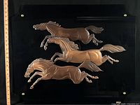 Front view showing full plaque with ruler for scale