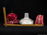 All three items side by side with rulers for scale