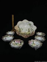 Front view showing serving bowl and six small bowls with ruler for scale