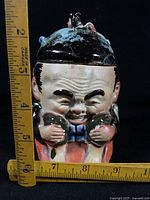 Front view with ruler showing height of ceramic figural humidor