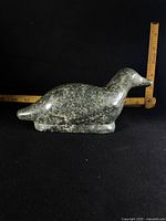 Profile view of soapstone bird showing shape, color and scale