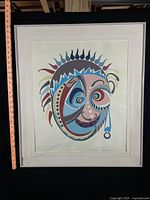 Full view of framed artwork with ruler for scale