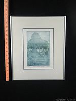 Front view of framed gravure with ruler for scale
