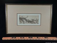 Full view of framed etching with ruler for scale