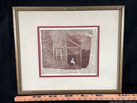 Framed etching with ruler for scale