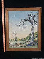 Front view of framed painting with ruler for scale