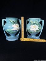 Front view of both matching Roseville Water Lily vases with ruler showing 6 in height
