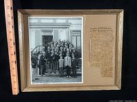 Overall shot of framed photo and clipping with ruler for scale