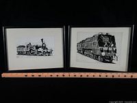 Both framed train prints with ruler for scale