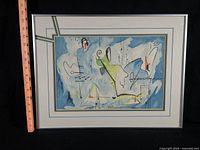 Full view of framed abstract watercolor with ruler indicating height
