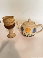 Teapot and chalice side by side