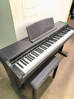 Full view of Technics SX-PC25 digital piano with bench