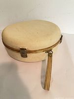 closed beige hard case with strap and latches