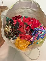 Bag filled with multicolor gift bows inside white handled bag