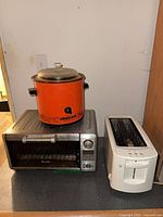 All three appliances grouped: Breville toaster oven, Rival Crock-Pot on top, Kenmore toaster to right