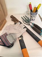 Overview of gloves, loppers, cultivator and screwdrivers