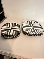 Two stacks of square patterned plates, dinner and salad sizes