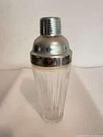 Full view of cocktail shaker showing cap, strainer section and body