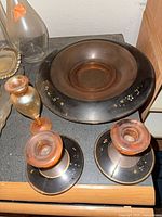 Set showing black bowl, two matching candlesticks, bud vase