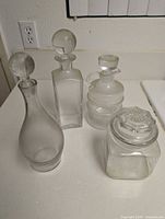 Group shot of four clear glass vessels