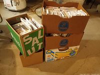 Five cardboard boxes stacked, filled with pattern envelopes