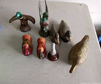All eight duck figurines displayed on table